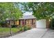 Charming brick home with a well-maintained front yard and a paved driveway leading to a two-car garage at 981 Ursula St, Aurora, CO 80011