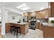 Modern kitchen with granite countertops, stainless steel appliances, and an island with bar stool seating at 981 Ursula St, Aurora, CO 80011