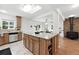 Bright kitchen boasts stainless steel appliances, a large island with granite countertops, and a skylight at 981 Ursula St, Aurora, CO 80011