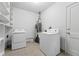 Laundry room featuring washer, dryer, water heater and storage shelving at 981 Ursula St, Aurora, CO 80011
