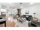 Open concept living area with hardwood floors, comfortable seating, and a clear view into the kitchen area at 981 Ursula St, Aurora, CO 80011