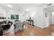 Spacious living room featuring hardwood floors, bright walls, and ample natural light from a large window at 981 Ursula St, Aurora, CO 80011