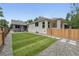 A landscaped backyard features lush grass and a detached grey garage at 3344 W 33Rd Ave, Denver, CO 80211