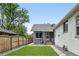 A lush backyard with well-maintained lawn and a detached grey brick garage at 3344 W 33Rd Ave, Denver, CO 80211