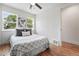 Bedroom offers hardwood floors, fresh paint, ceiling fan, and large windows offering natural light at 3344 W 33Rd Ave, Denver, CO 80211