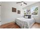 Bright bedroom boasts hardwood floors, fresh paint, ceiling fan, and large windows for ample natural light at 3344 W 33Rd Ave, Denver, CO 80211