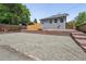 Detached grey brick garage and red brick retaining wall create privacy at 3344 W 33Rd Ave, Denver, CO 80211