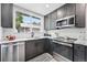 Contemporary kitchen with stainless steel appliances, gray cabinetry, and a bright, airy feel at 3344 W 33Rd Ave, Denver, CO 80211
