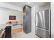 Kitchen view features gray cabinets, stainless steel refrigerator, granite countertops, and a view of the living room at 3344 W 33Rd Ave, Denver, CO 80211