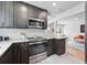 Modern kitchen features gray cabinets, granite countertops, stainless steel appliances, and subway tile backsplash at 3344 W 33Rd Ave, Denver, CO 80211