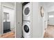 Hallway view shows stacked laundry unit, with bathroom and hall access at 3344 W 33Rd Ave, Denver, CO 80211
