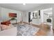Bright living room with hardwood floors, modern decor, and an open view to the updated kitchen at 3344 W 33Rd Ave, Denver, CO 80211