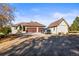 Home's front exterior, three-car garage, and detached workshop at 12247 Piney Lake Rd, Parker, CO 80138