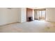 Spacious living room featuring a brick fireplace, neutral carpet, and sliding doors to a private balcony at 800 N Pearl St # 602, Denver, CO 80203