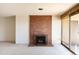 Bright living room showcases a brick fireplace, neutral carpet, and sliding doors to a private balcony at 800 N Pearl St # 602, Denver, CO 80203