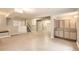 Spacious unfinished basement featuring neutral tile floors, built-in storage and access to the staircase at 7498 W Saratoga Pl, Littleton, CO 80123