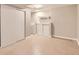Finished basement featuring tile floor, storage cabinets and a sink at 7498 W Saratoga Pl, Littleton, CO 80123