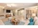 Finished basement with a entertainment area, built-in bar and cabinets, and access to the staircase at 7498 W Saratoga Pl, Littleton, CO 80123