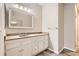 Bathroom vanity with ample storage, light countertop, and a decorative framed mirror at 7498 W Saratoga Pl, Littleton, CO 80123