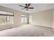 Bedroom featuring neutral walls, carpet, three windows with natural light and a ceiling fan at 7498 W Saratoga Pl, Littleton, CO 80123
