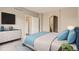 Comfortable bedroom featuring a large bed, dresser, and calming decor at 7498 W Saratoga Pl, Littleton, CO 80123