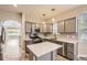 Updated kitchen showcasing a center island, stainless steel appliances, and stylish lighting at 7498 W Saratoga Pl, Littleton, CO 80123