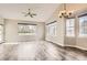 Bright living room featuring hardwood floors, large windows, and natural light at 7498 W Saratoga Pl, Littleton, CO 80123