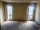 A view of a carpeted bedroom with two windows at 805 E 7Th Ave # 8, Denver, CO 80218
