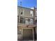 Two-story home exterior featuring a balcony, garage, brick chimney and modern siding at 805 E 7Th Ave # 8, Denver, CO 80218