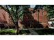 A view of the exterior of the brick home with ample green foliage and trees at 805 E 7Th Ave # 8, Denver, CO 80218