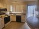 A kitchen with white cabinets, appliances, and tiled counters and floors at 805 E 7Th Ave # 8, Denver, CO 80218