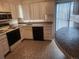 A kitchen with white cabinets, appliances, and tiled counters and floors at 805 E 7Th Ave # 8, Denver, CO 80218