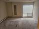 A view of the living room with carpet and a window at 805 E 7Th Ave # 8, Denver, CO 80218