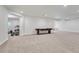 Spacious basement recreation room with carpeted floors and game table at 3308 Carabiner St, Castle Rock, CO 80108