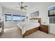 Main bedroom with plush carpet, large windows, and ceiling fan at 3308 Carabiner St, Castle Rock, CO 80108