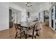 Open concept dining room with a rustic table, hardwood floors, and kitchen access at 3308 Carabiner St, Castle Rock, CO 80108