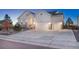 Two-story white farmhouse with a two-car garage and neatly landscaped yard at 3308 Carabiner St, Castle Rock, CO 80108