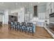 Modern kitchen with white cabinets, a large island, and a herringbone backsplash at 3308 Carabiner St, Castle Rock, CO 80108