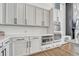 Modern kitchen with white cabinets, built-in oven and microwave, and herringbone backsplash at 3308 Carabiner St, Castle Rock, CO 80108