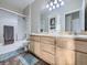 Well-lit bathroom with a shower-tub combo and a double sink vanity at 8481 W Union Ave # 4-203, Littleton, CO 80123