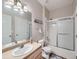 Bright bathroom featuring a single sink vanity and a shower-tub combo at 8481 W Union Ave # 4-203, Littleton, CO 80123
