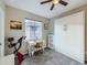 This bedroom features a murphy bed, gray carpet, a ceiling fan, and a desk for a simple, modern space at 8481 W Union Ave # 4-203, Littleton, CO 80123