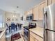 A kitchen leads to the dining room with a table and four chairs, with warm natural lighting at 8481 W Union Ave # 4-203, Littleton, CO 80123