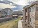 An apartment exterior shows a walkway and views of the yard and another home on a cloudy day at 8481 W Union Ave # 4-203, Littleton, CO 80123