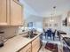 A view of the kitchen sink highlights the open layout into the living and dining areas at 8481 W Union Ave # 4-203, Littleton, CO 80123
