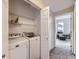 Convenient laundry closet with stacked washer and dryer, plus storage shelves at 8481 W Union Ave # 4-203, Littleton, CO 80123
