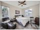 Comfortable main bedroom with large windows, ceiling fan, and relaxing chair at 8481 W Union Ave # 4-203, Littleton, CO 80123
