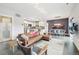 Open-concept living room featuring a modern kitchen, dining area, hardwood floors, and comfortable leather seating at 3644 Pinedale St, Boulder, CO 80301