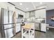 Bright kitchen with stainless steel appliances, ample cabinet space and a kitchen island at 3644 Pinedale St, Boulder, CO 80301