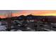 Scenic view of the mountains at sunset over buildings and parking lot at 3644 Pinedale St, Boulder, CO 80301